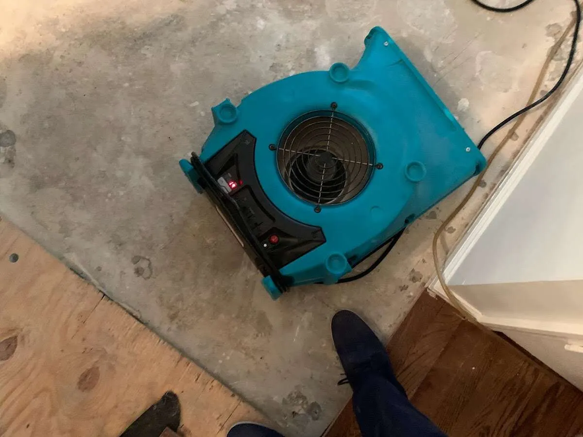 Air mover drying subfloor during Commercial Water Damage Restoration in Centennial
